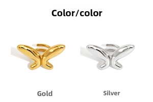 Detail view of butterfly open rings in polished gold and silver stainless steel finishes