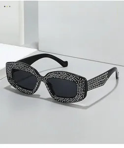 Detailed view of luxury black cat eye sunglasses with shimmering rhinestone encrusted frames