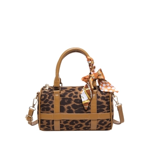 Leopard print Boston handbag with brown leather trim and a decorative silk scarf
