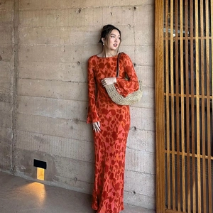 Detail view of red floral printed long sleeve maxi dress with slim fit and flared cuffs