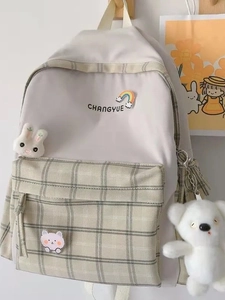 Minimalist canvas backpack in cream and green plaid with cute animal patches and bear charm