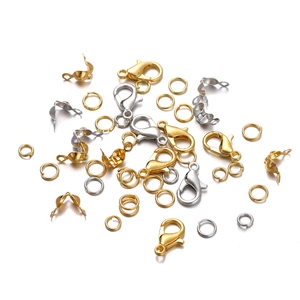 Close-up of gold and silver lobster clasps and jump rings for DIY jewelry making