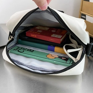 Japanese style white functional crossbody bag with spacious interior and black shoulder strap