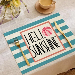 Detail of linen placemat with Hello Sunshine print and beach ball on a dining table