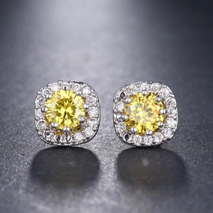 Macro shot of silver stud earrings featuring large yellow square-cut cushion zircons