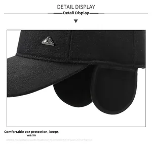 Detail of warm black baseball cap with ear flaps and decorative metal hardware