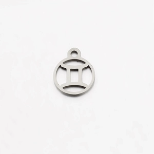 Macro detail of silver stainless steel Gemini zodiac charm for DIY jewelry making