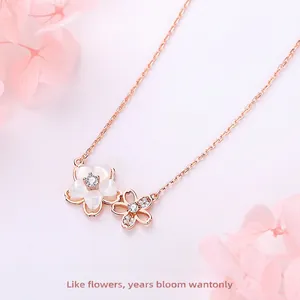 Elegant rose gold cherry blossom necklace with white shell and sparkling crystals