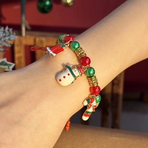 Adjustable Christmas beaded bracelet featuring Santa Claus charms and red woven rope