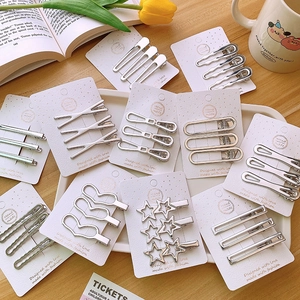 Set of 3 silver Y2K metallic hair clips in hollow geometric shapes on a card