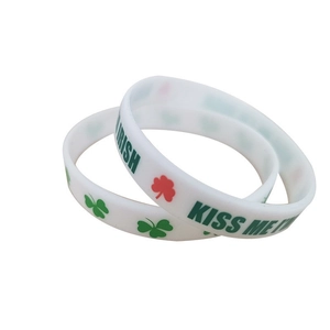White silicone wristband with green shamrocks and Kiss Me I'm Irish text for party