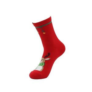 Detail of red Christmas crew sock featuring a reindeer pattern and green striped cuff