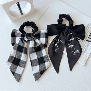 Bow hair scrunchies with black white plaid and skull patterns on white background