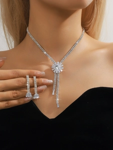 Close-up of sparkling silver rhinestone tassel necklace and matching long earrings set