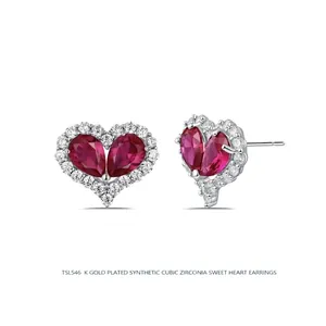 Elegant gold plated heart stud earrings featuring red drop-shaped cubic zirconia stones