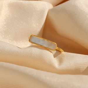 Macro detail of 18K gold plated ring with white rectangular mother of pearl inlay