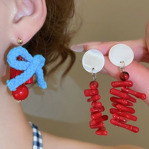 Detailed close-up of handmade shell resin tassel earrings with elegant bow knot texture