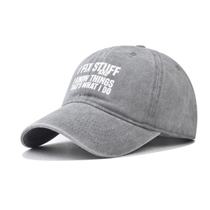 Distressed washed cotton baseball cap in grey with white printed slogan on white background