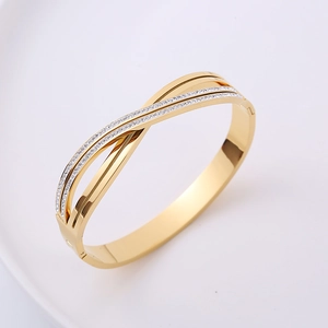 Elegant gold-tone cross infinity bracelet with shimmering crystal pave setting