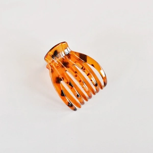 Classic amber tortoiseshell hair claw clip for elegant buns on a clean white background