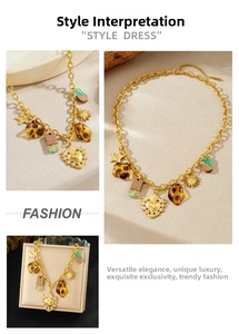 Detail shot of vintage gold-plated heart sun and leopard acrylic pendant necklace