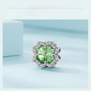 Detailed macro view of S925 sterling silver green clover charm with pavé cubic zirconia
