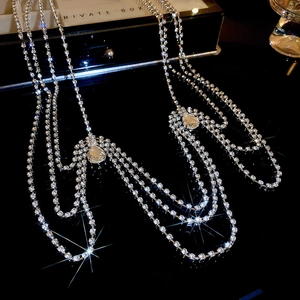 Macro view of multi-layer rhinestone shoulder chain with a sparkling teardrop crystal