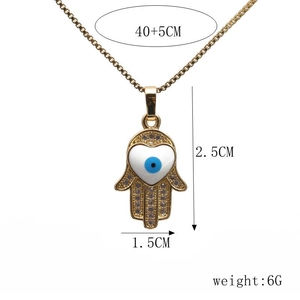 Hamsa Hand pendant with blue evil eye and zircons on gold chain, 2.5cm by 1.5cm detail