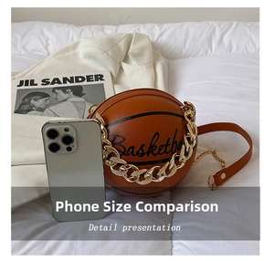 Macro view of basketball-shaped shoulder bag with chain showing phone size comparison