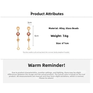 Detail view of gold alloy earrings with purple glass beads and size dimensions
