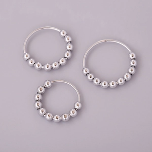Detailed view of silver rotatable bead rings for anxiety relief and stress reduction