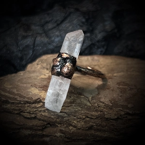 Macro detail of natural raw crystal stone ring with handcrafted hammered metal texture
