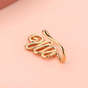 Macro shot of gold non-piercing U-shaped nose clip with spiral design and shiny finish
