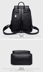 Detail view of black textured leather backpack with back zipper and bottom brand logo