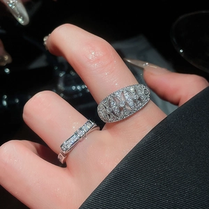 Macro view of 18k gold plated bow and oval rings with sparkling zircon pavé on fingers