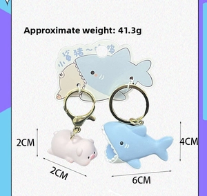 Detail showing cartoon shark and pig keychains with weight and size measurements