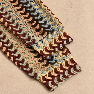 Detail of colorful wave crochet knit sleeve with hollow texture on loose shirt
