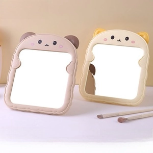 Close-up of cute animal-themed foldable desktop makeup mirrors with wavy frame design