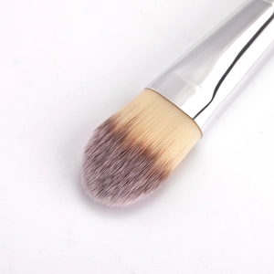 Macro shot of gradient fiber bristles and silver metal ferrule on a professional foundation brush