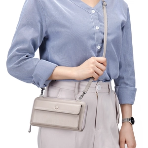 Light gray touchscreen crossbody phone bag with pebble leather and adjustable strap