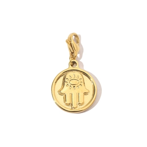 Macro detail of golden Hamsa hand pendant with lobster clasp and tree of life motifs