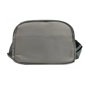 Detail view of the gray nylon fanny pack showing a black zipper and adjustable strap