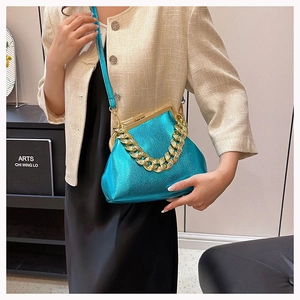 Detail view of lake blue metallic leather crossbody bag with chunky gold chain handle