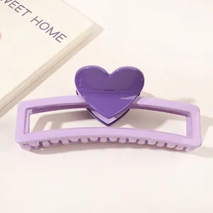 Detail of a dual-tone purple heart hair claw clip with a glossy resin finish