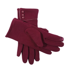 Detail of burgundy winter gloves showing three decorative buttons and touch screen tips