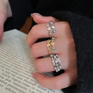 Three-layer pearl and zircon open ring set in gold and silver finish on hand