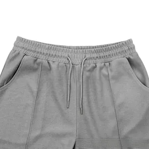 Detail of grey waffle knit shorts with elastic waistband and adjustable drawstring cord