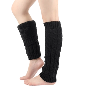 Detail of black cable knit leg warmers showing stretch and texture on legs
