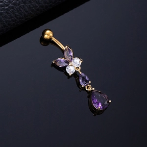 Golden butterfly navel ring with purple zircon tassels on black reflective background