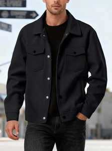 Detail of black corduroy jacket fabric texture with silver metal buttons and chest pockets